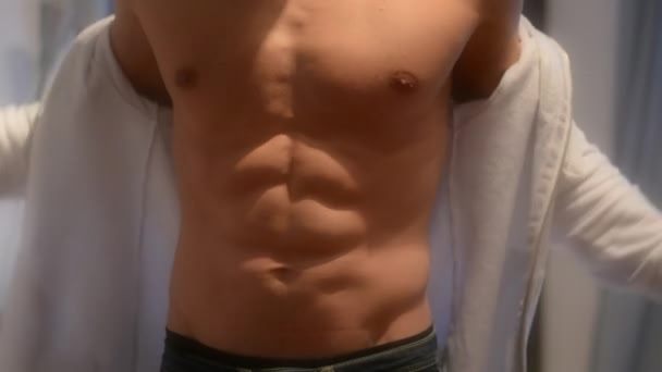 depositphotos_100871334-stock-video-young-fit-man-opening-sweater